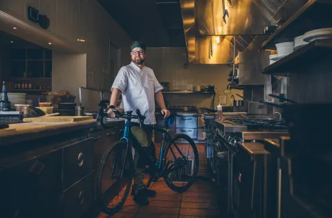 White chef with bike in kitchen