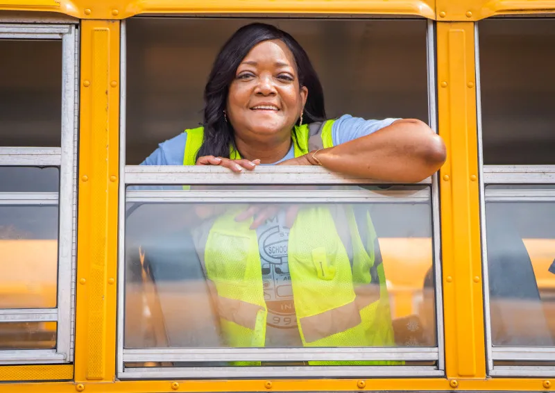 Black woman looking at bus window