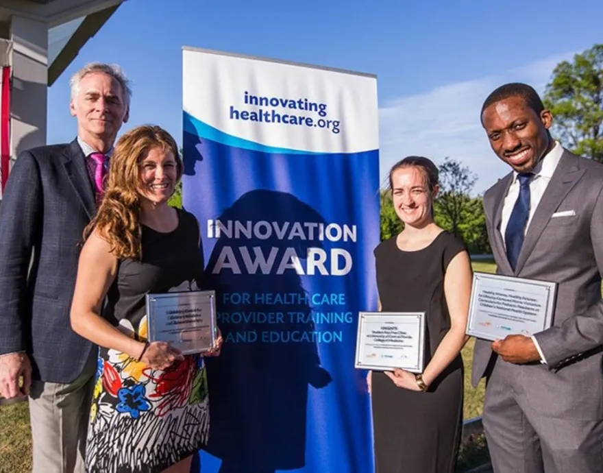 Dr. Essel and 3 other people receiving innovation award