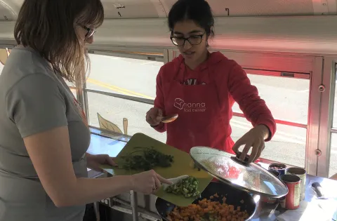 Women serving food in bus