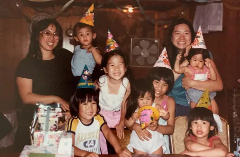 Old photo of asian american family with several people and kids