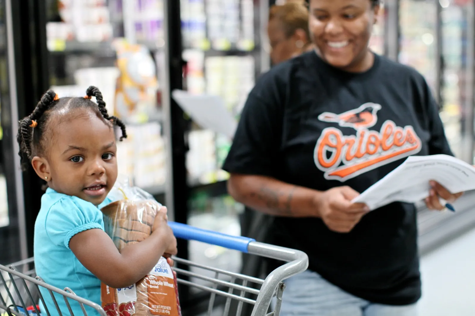 mom and child shopping at grocery store