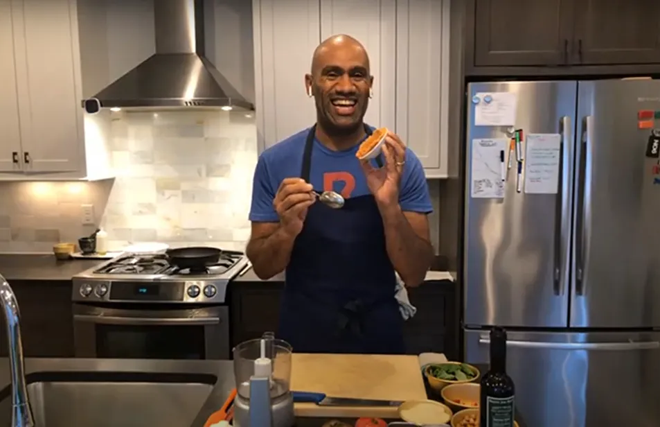 Chef smiling at the camera inside of the kitchen