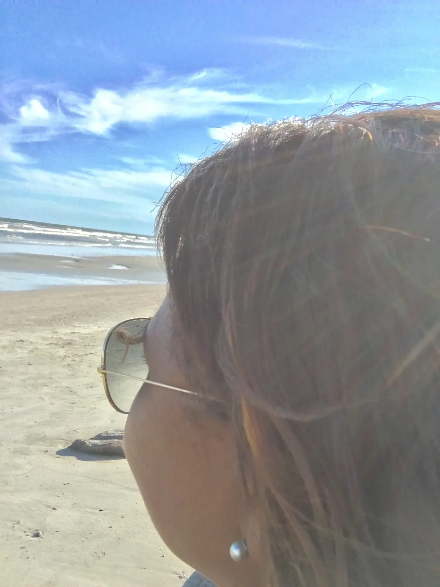 Picture of looking behind a woman looking into the ocean