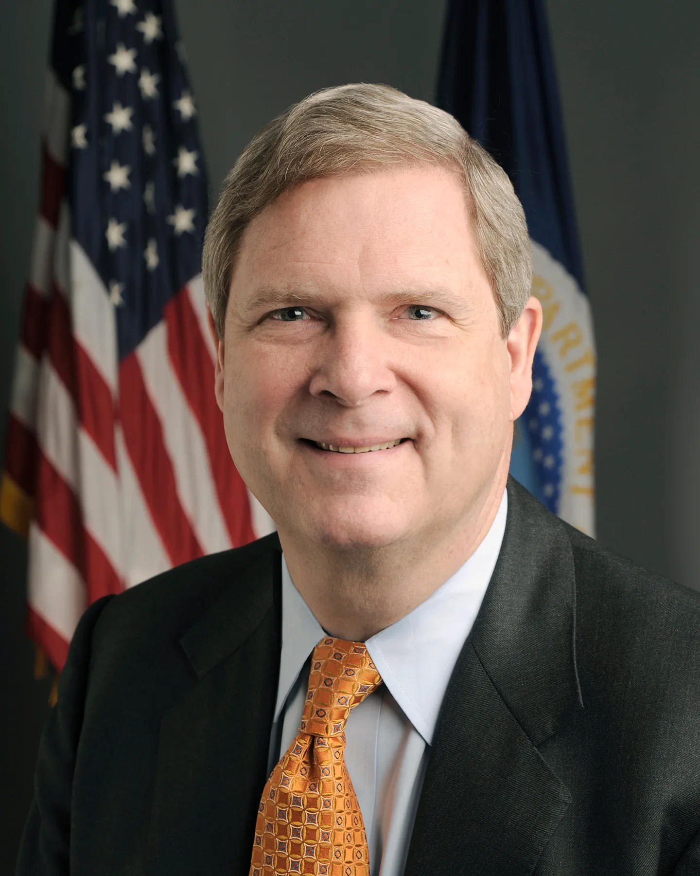 Secretary of Agriculture Vilsack looking at the screen
