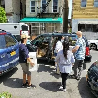 Food delivery several people bringing food to a car