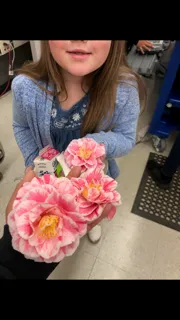 girl handing flower