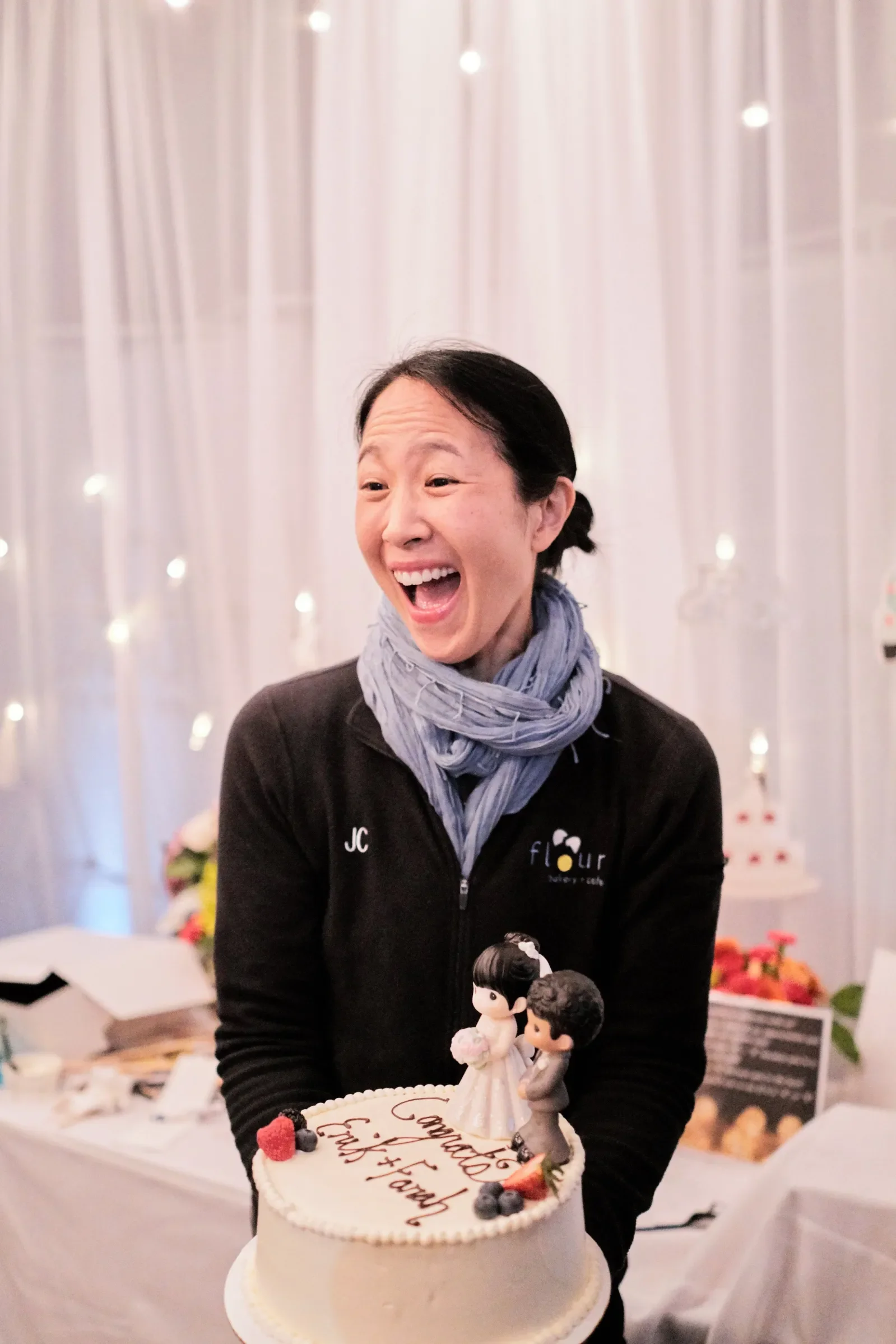 Chef Joanne Chang in front of a wedding cake