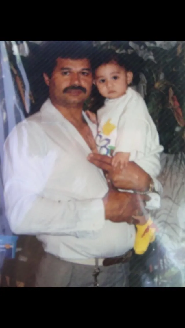 Old photo of man with moustache holding baby