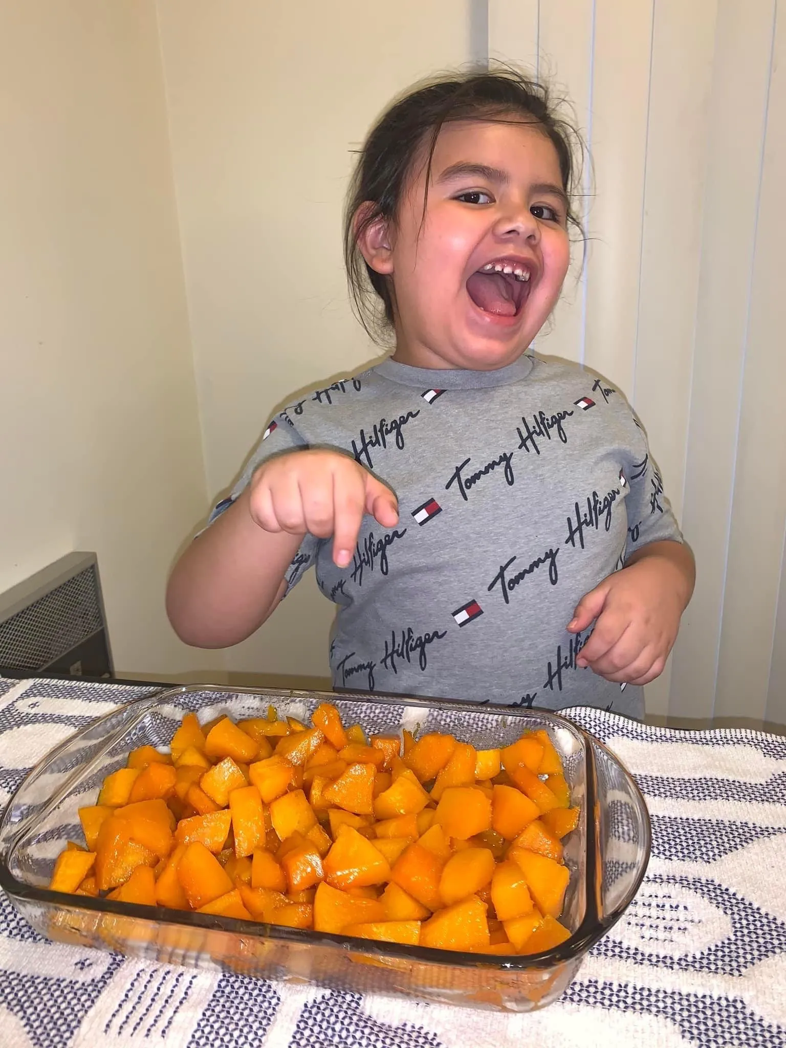 Boy pointing a chopped cooked squash