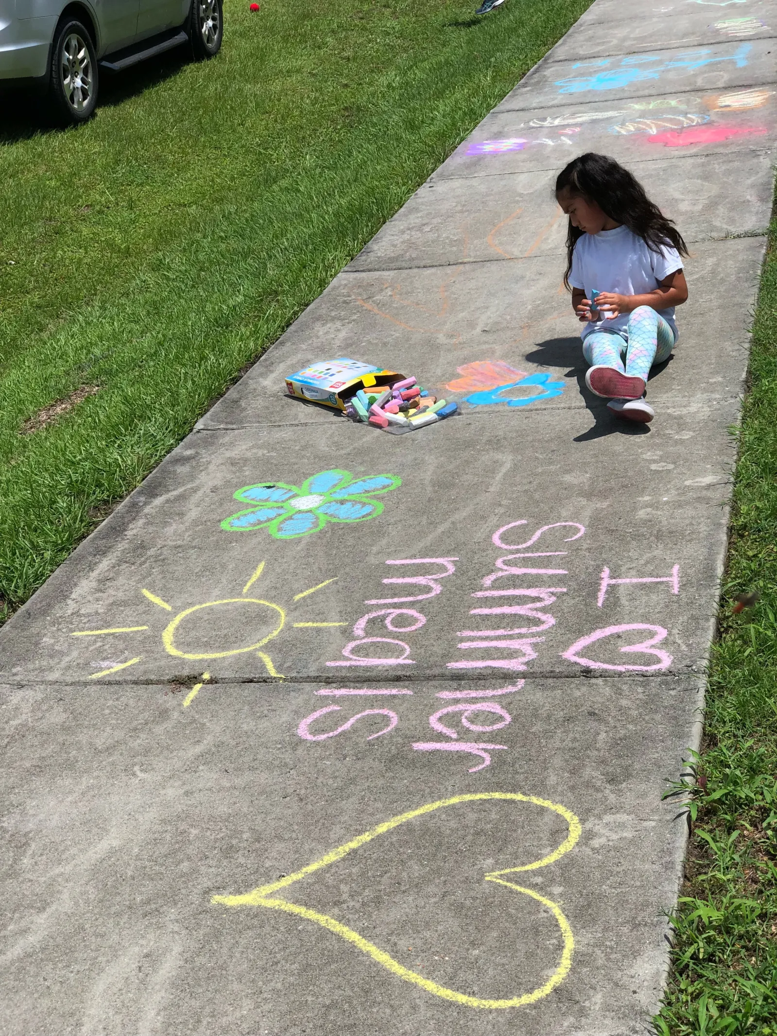 Girl writing with chalk on ground I love summer meals