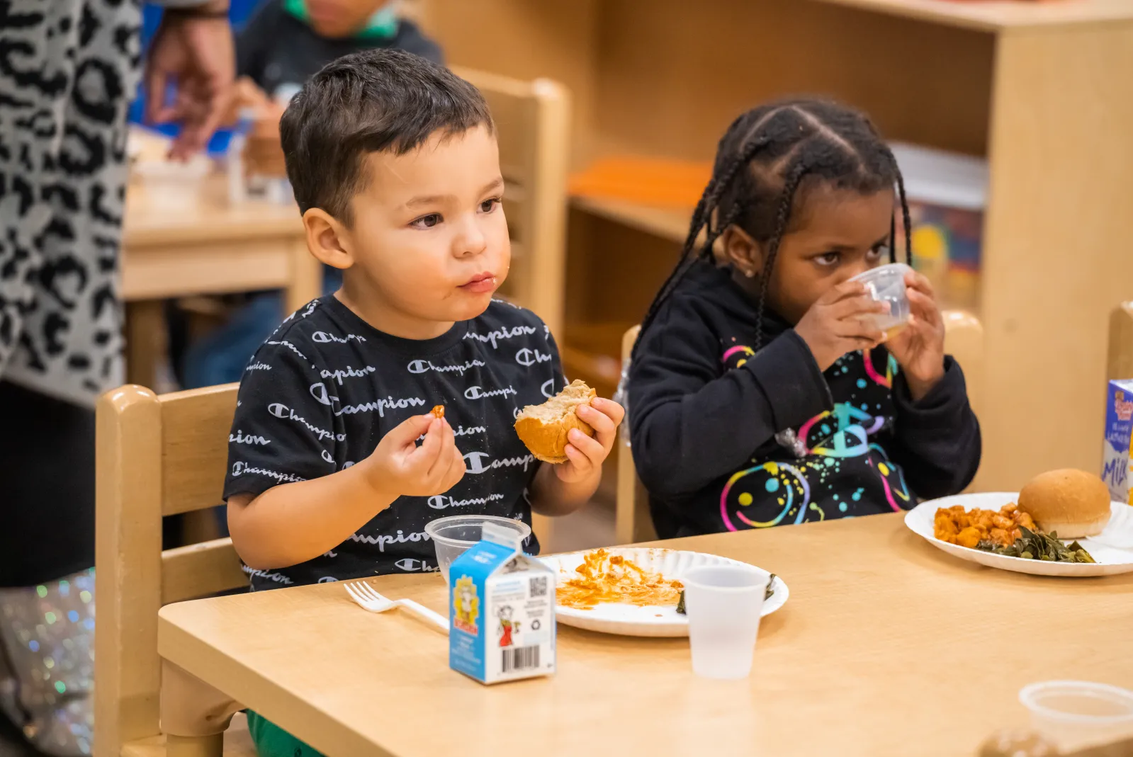 Little boy eating in classroom