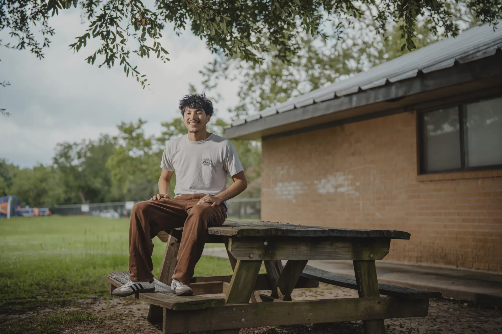 Portrait of teen sitting at picnic table