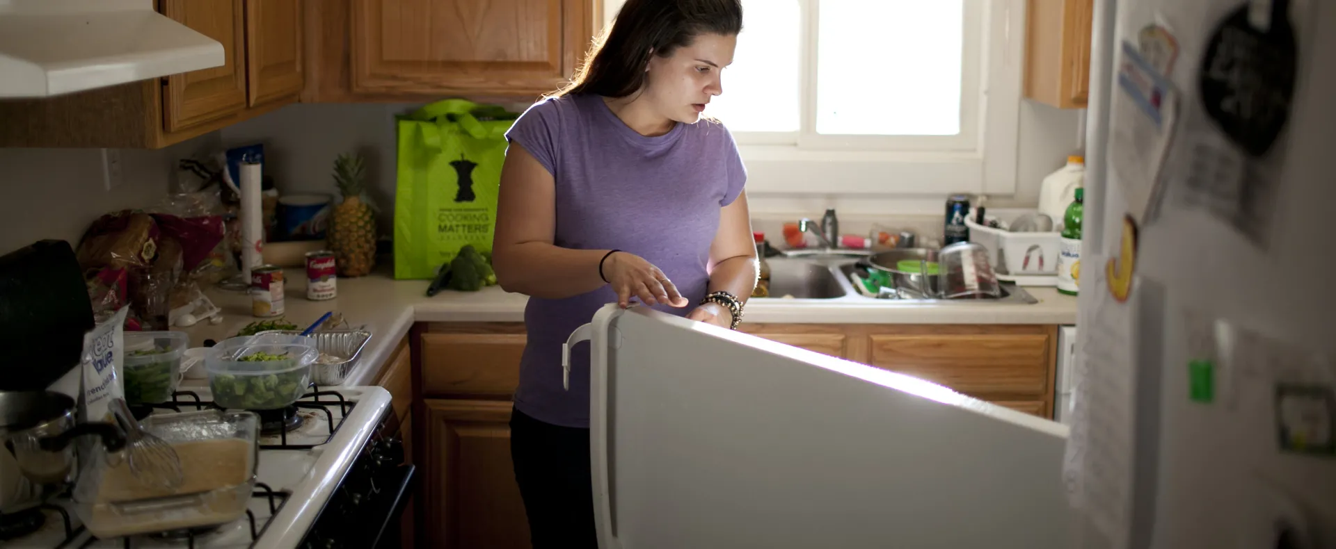 Woman looking into refrigerator