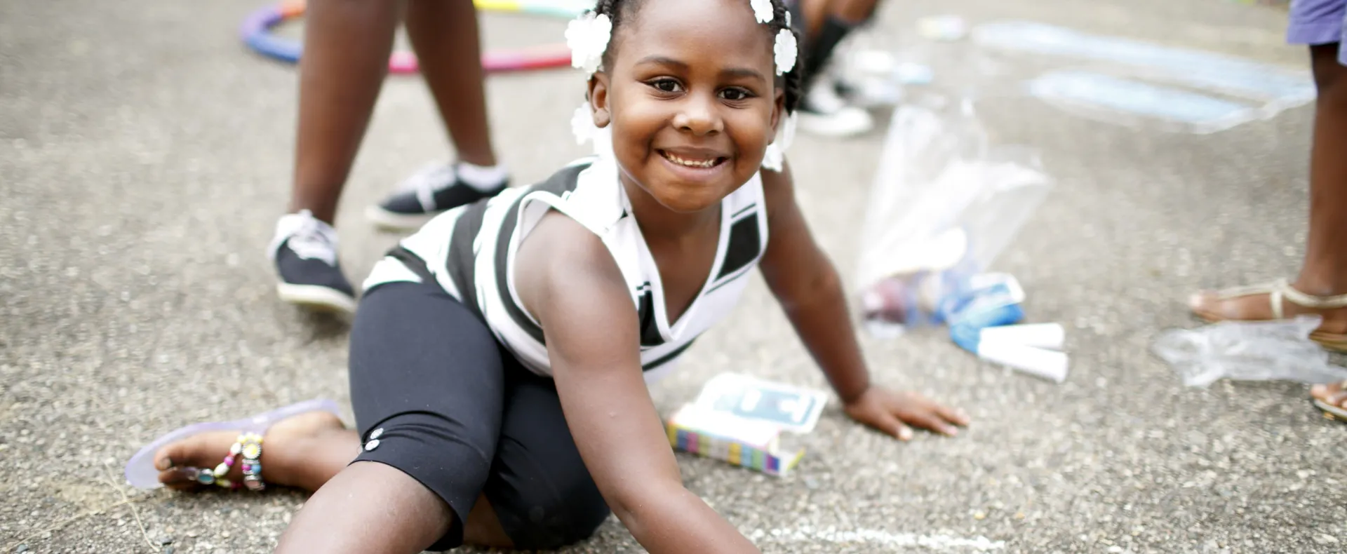 Girl drawing with chalk outside