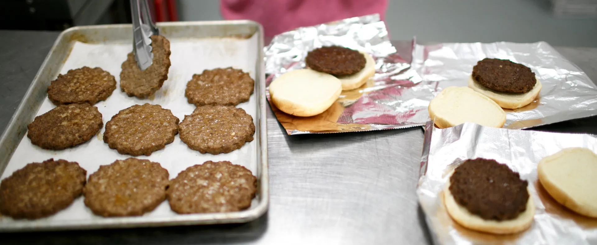 Hamburgers being prepared in an industrial kitchen