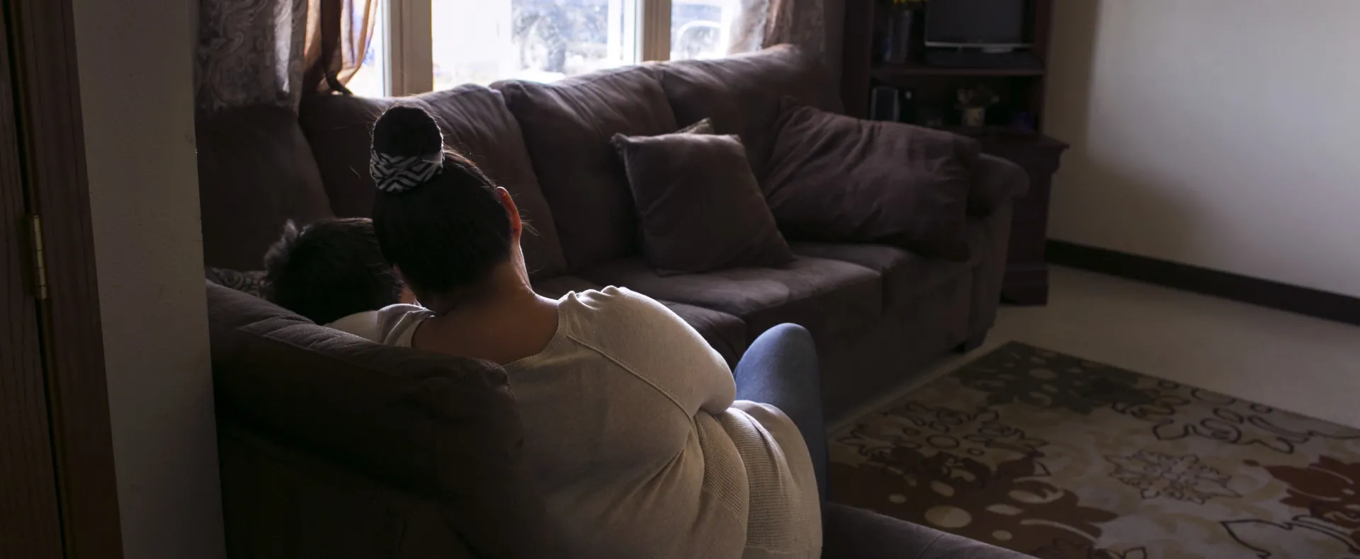 Mother and child sitting in living room