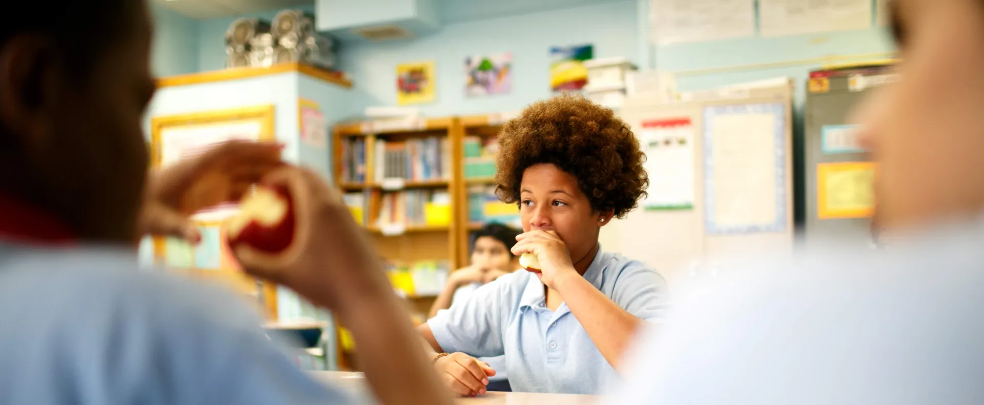 Teens eating in a school cafeteria