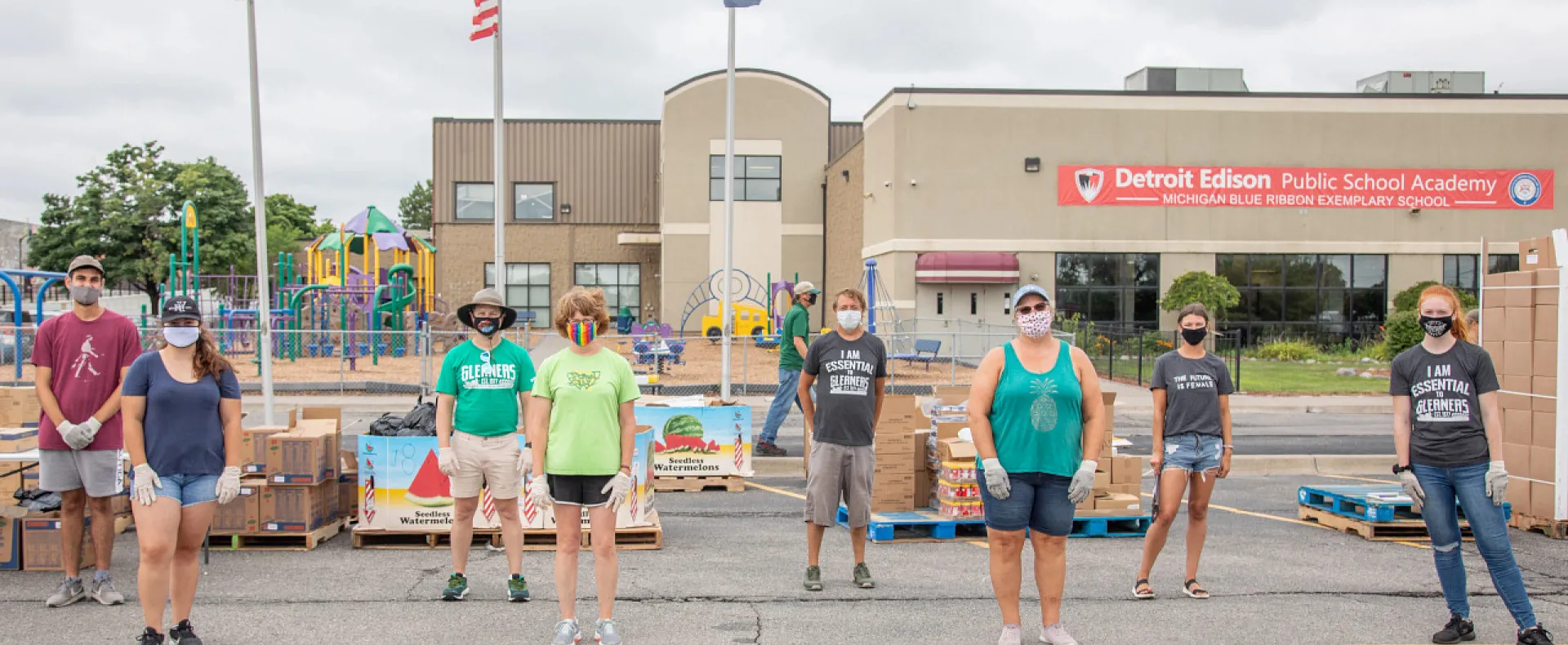 Volunteers wearing masks in a food distribution site