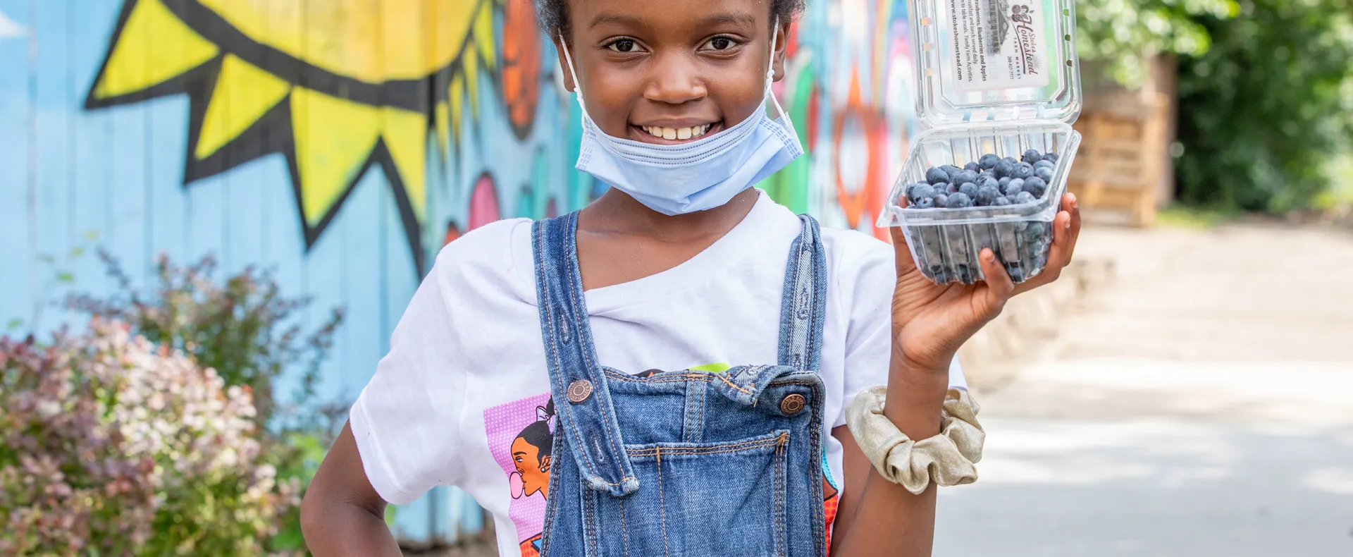 Little girl with mask outside