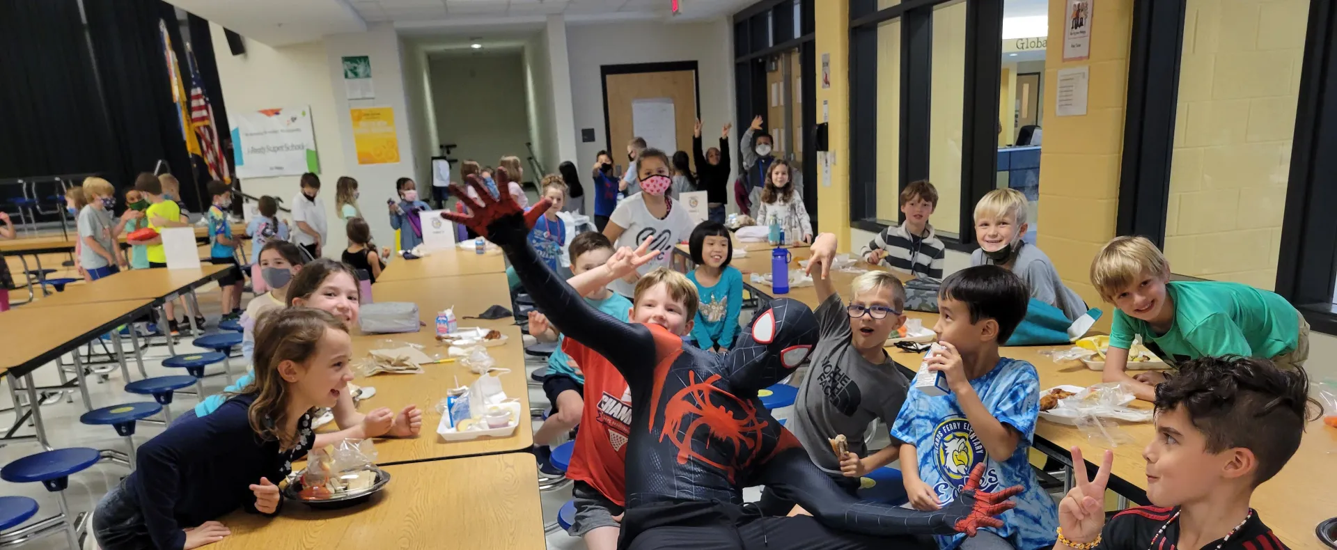 man dressed as spiderman with kids