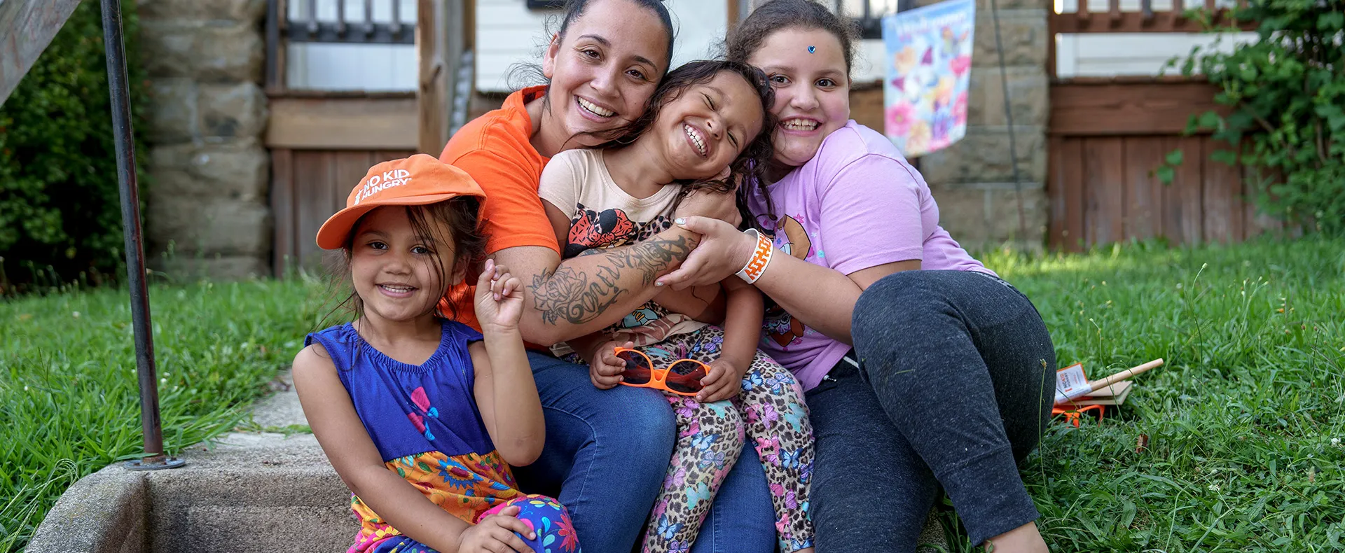Family sitting on stoop during summertime