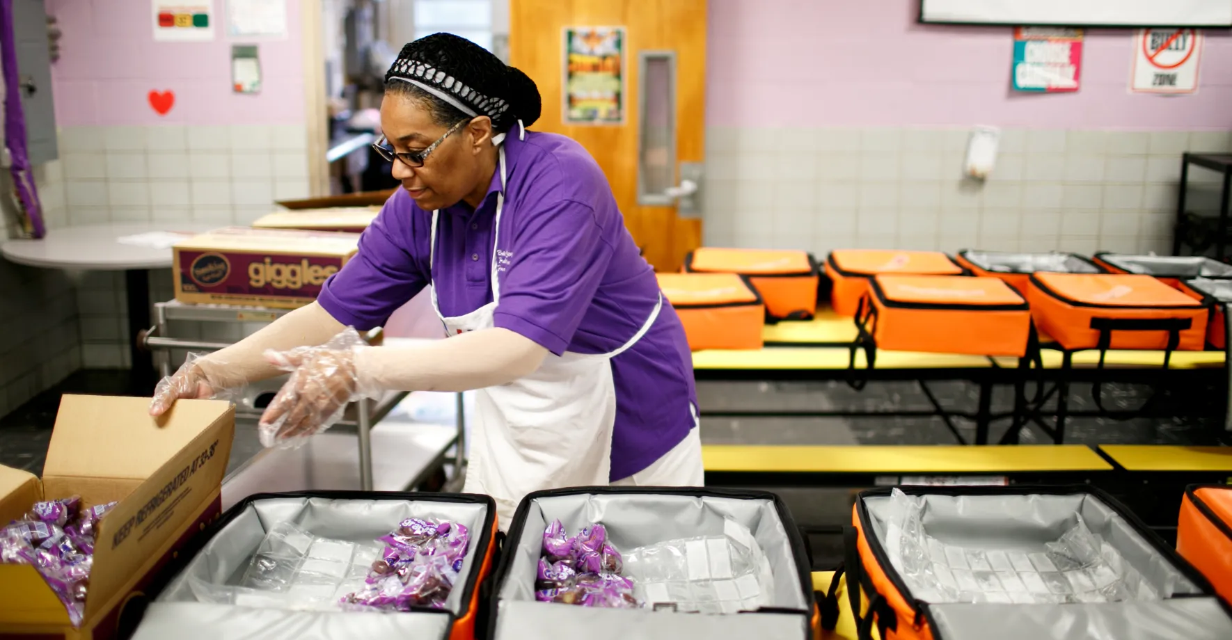 A cafeteria worker preparing breakfast