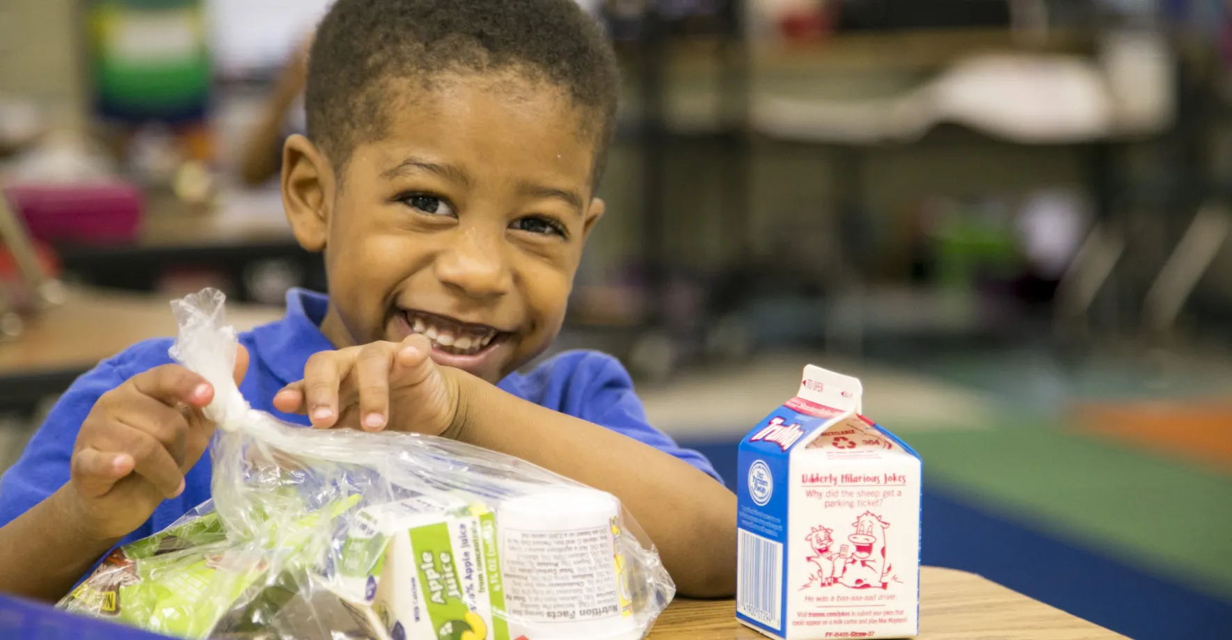 A little boy eating school breakfast