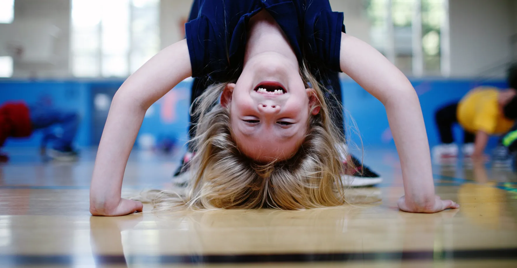 A little girl doing a headstand
