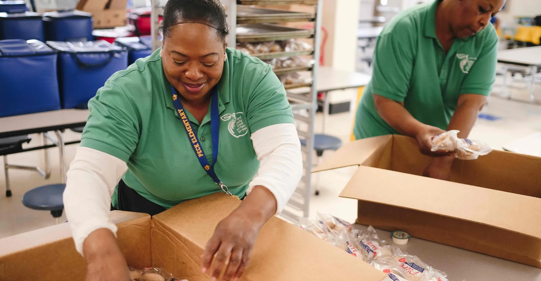 Cafeteria workers packing bag meals during the coronavirus