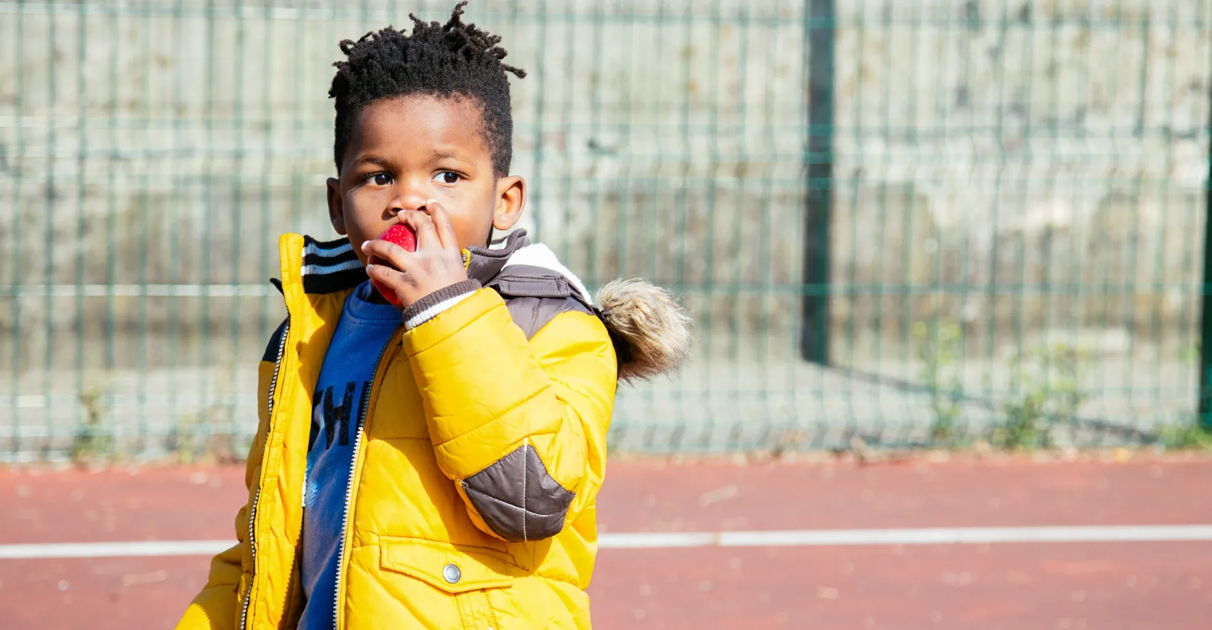 A little boy eating an apple