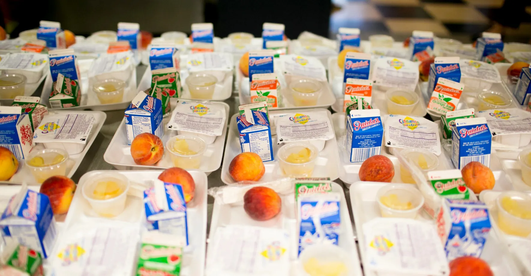 Trays of meals with milk and fruit