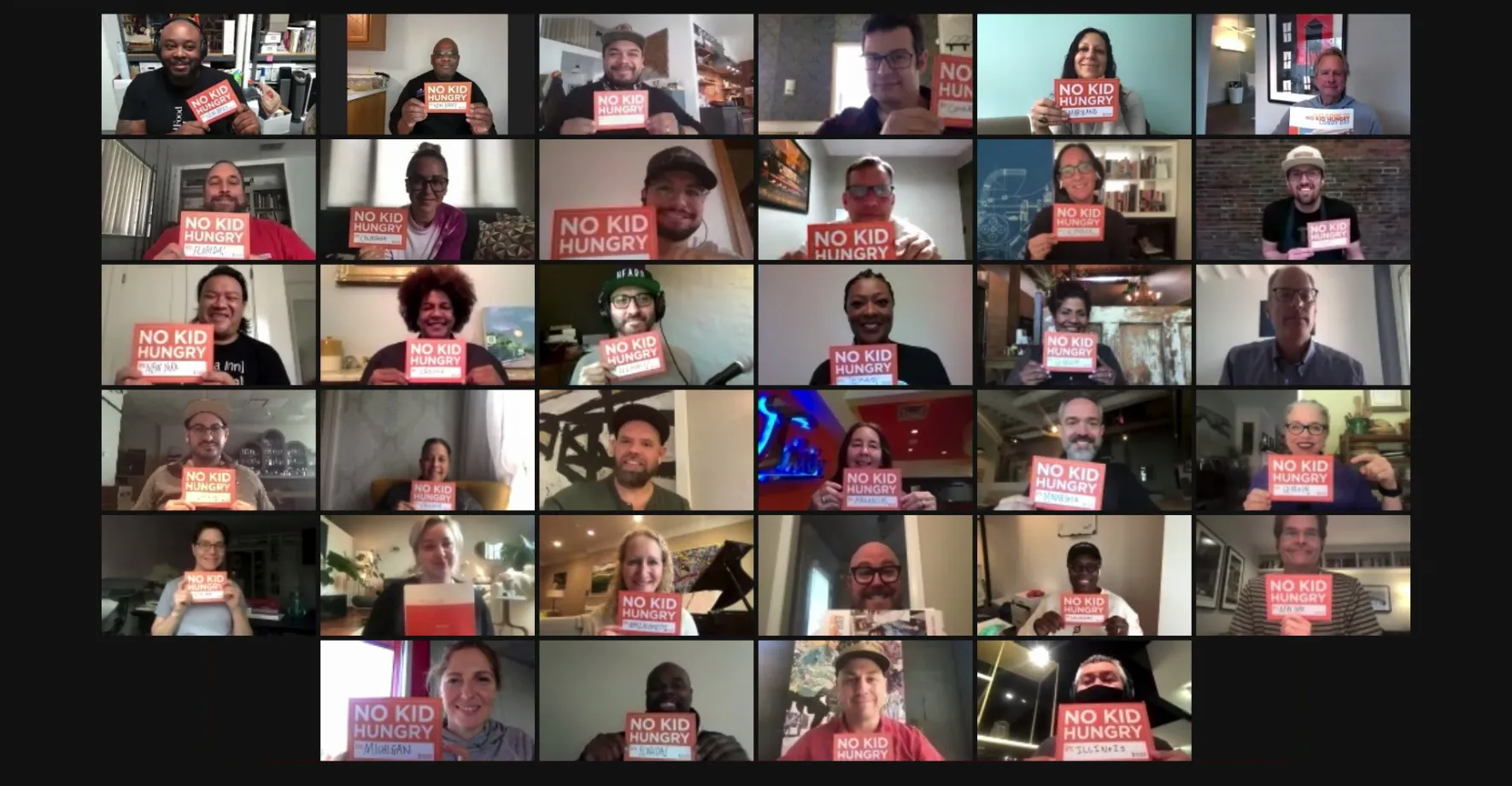 Zoom meeting with multiple people holding No Kid Hungry signs