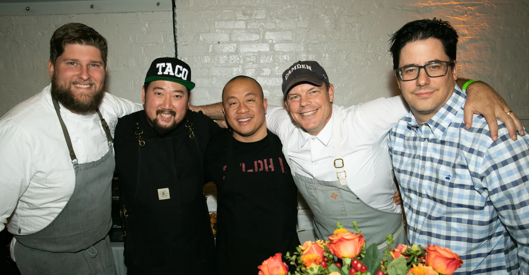 5 chefs hugging and posing for picture