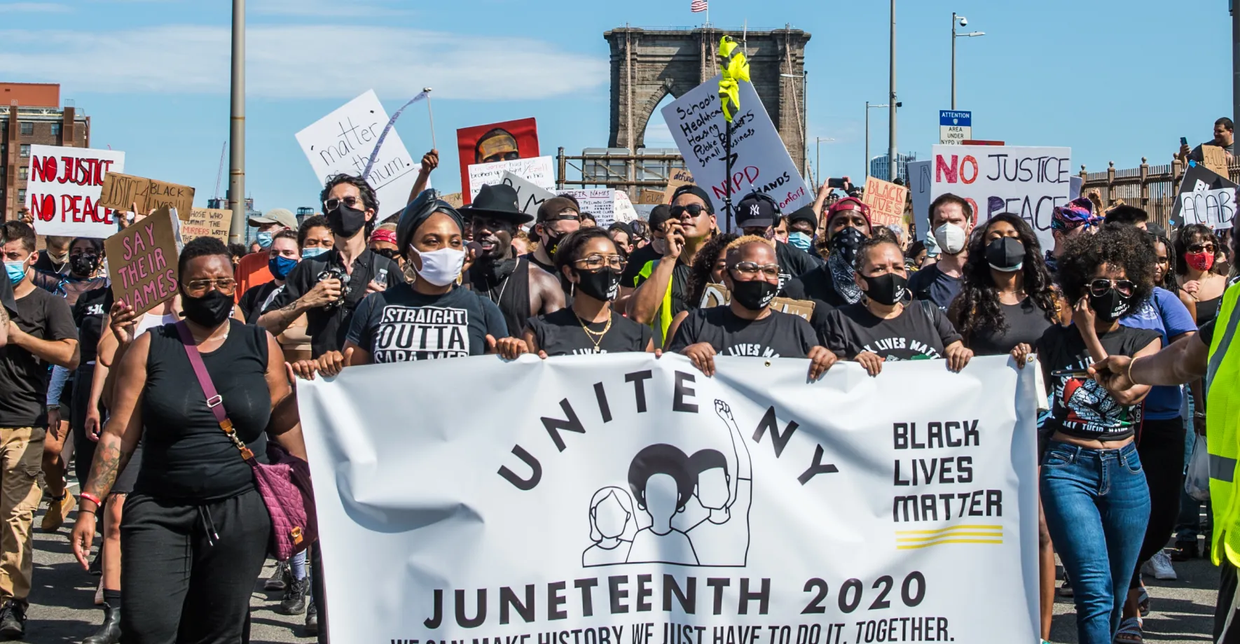 People marching with a Juneteenth banner.