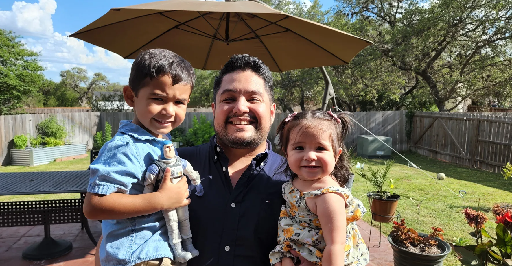 Franco and his kids. Man holding two young kids