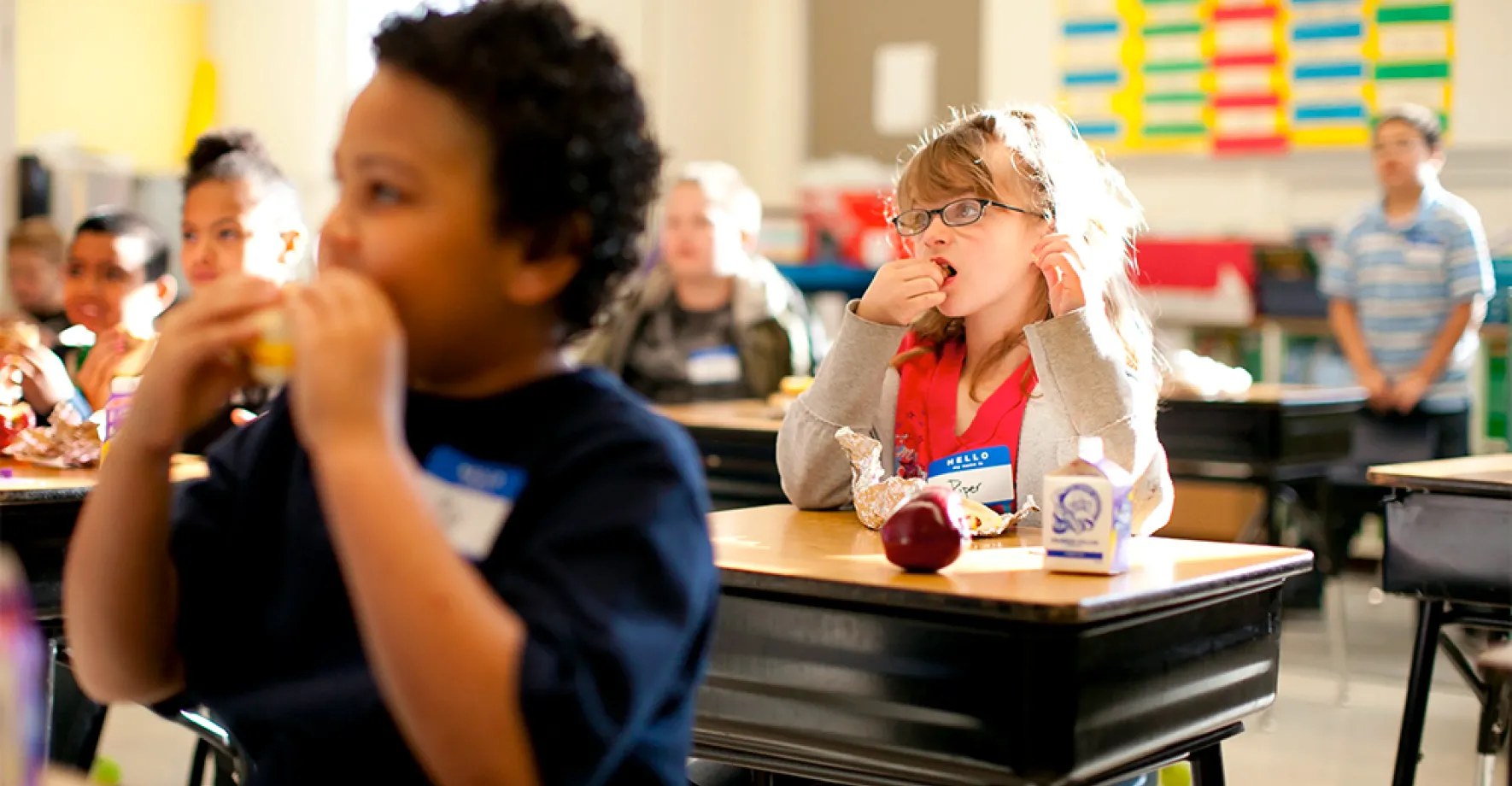 Kids eating breakfast at desks