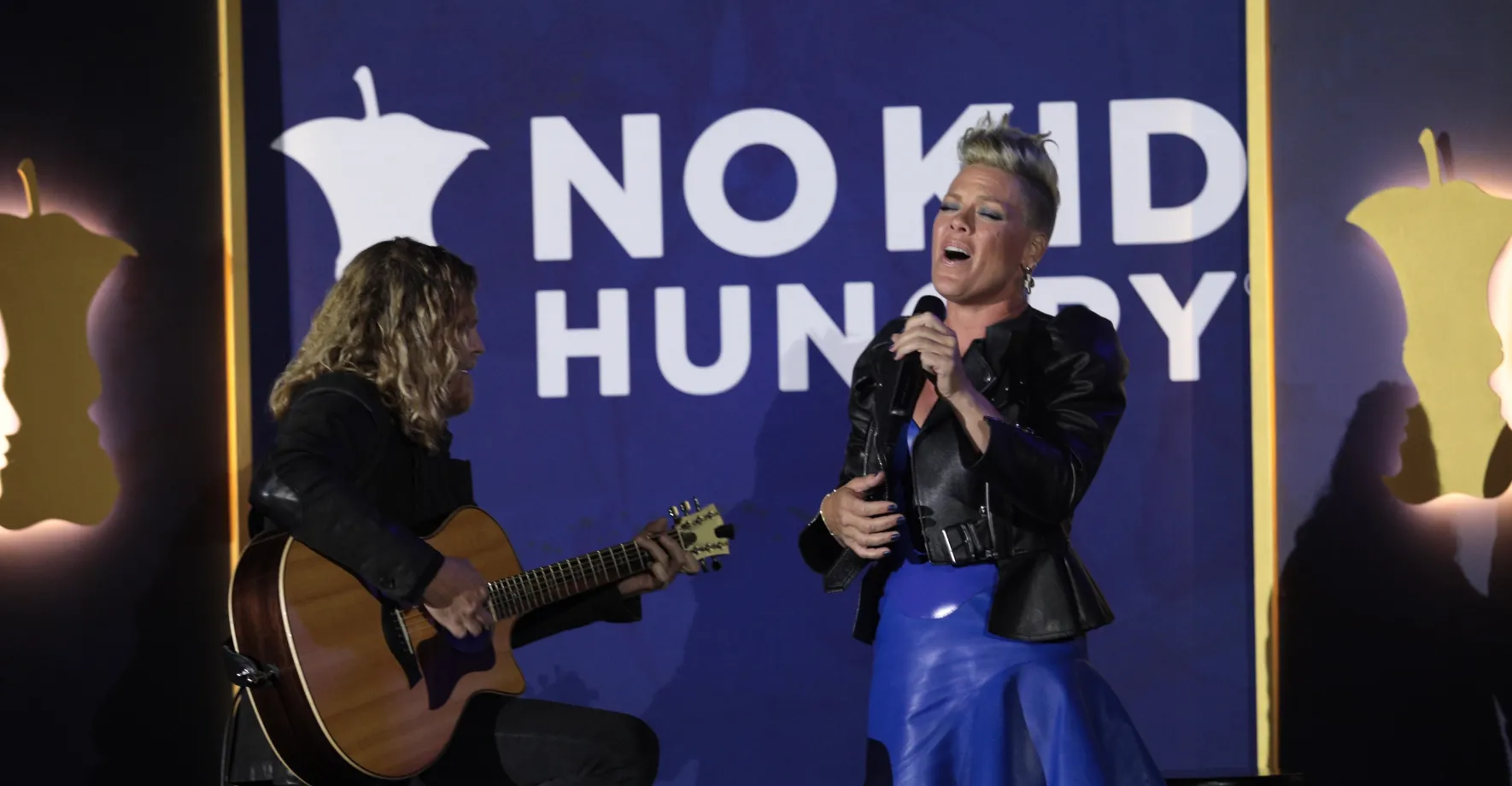 Pink singing with white guitarist