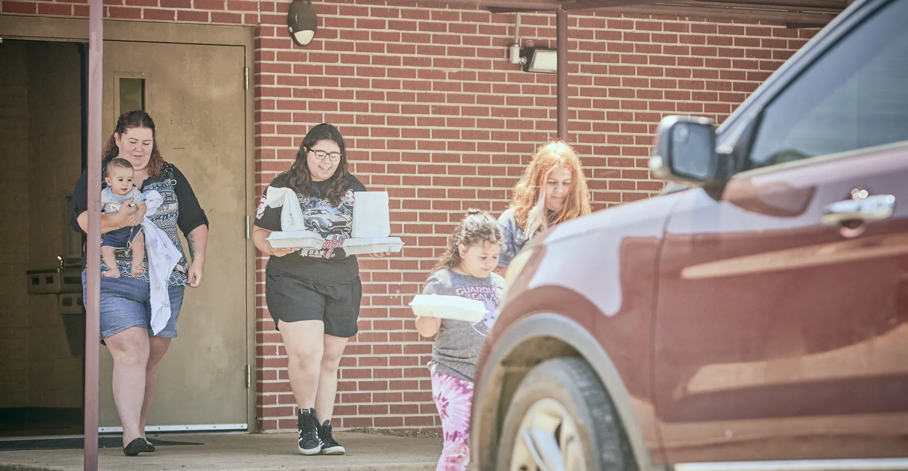 Family picking up meal in school