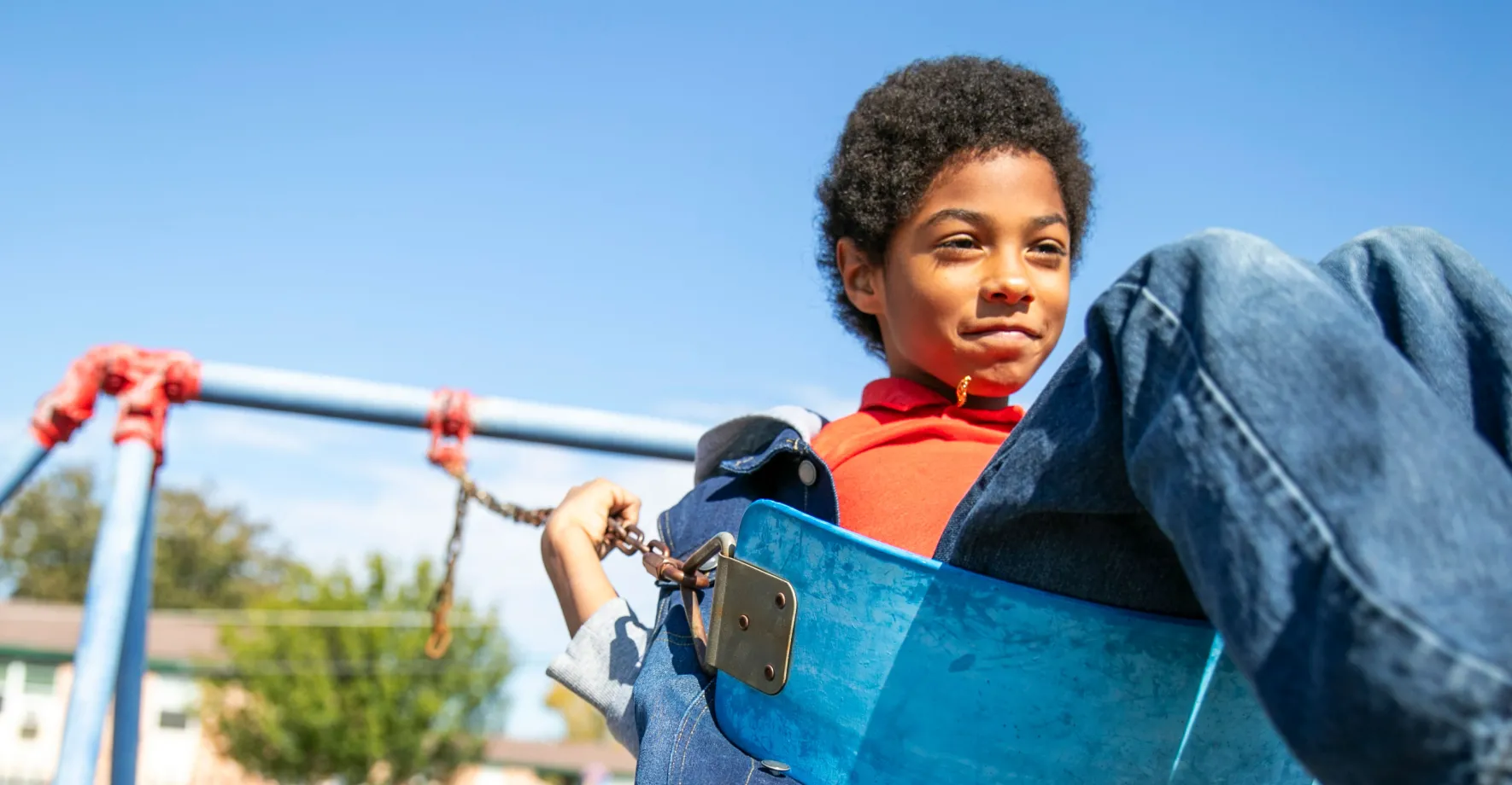 Kid on swing in summer