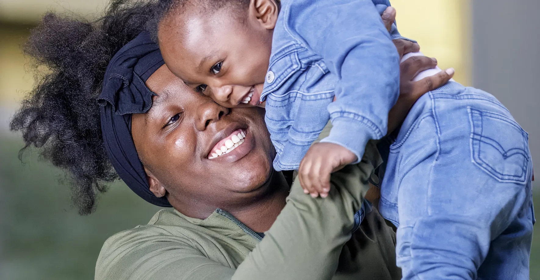 Mom holding child and smiling