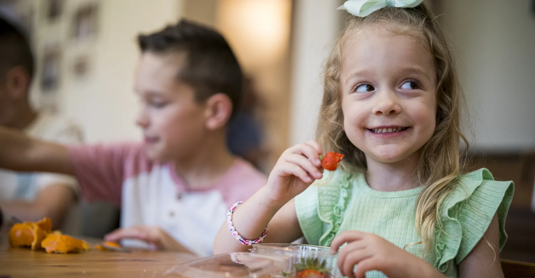 White little girl eating strawberries