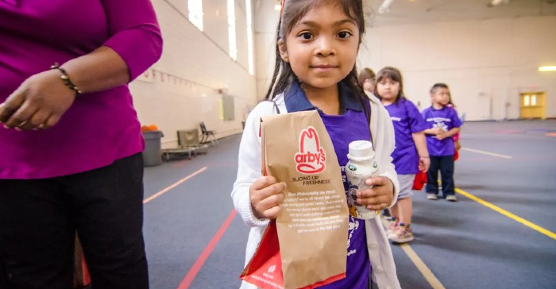 Little Latina girl with arby's bag