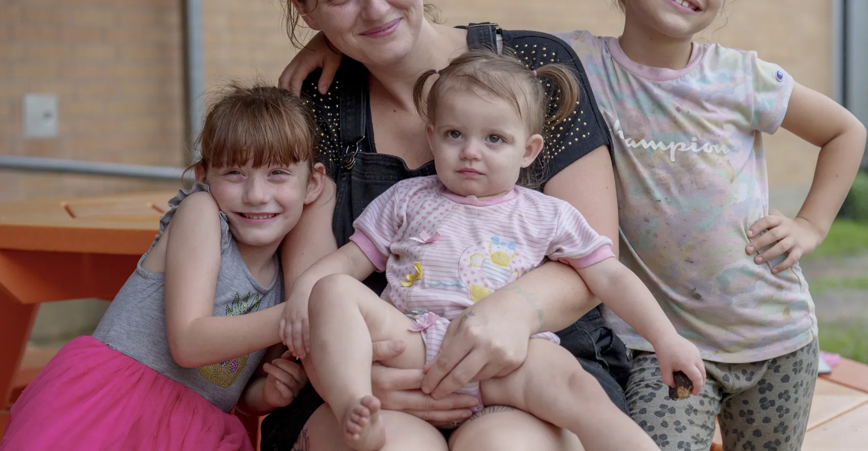 Mom at picnic table with three kids