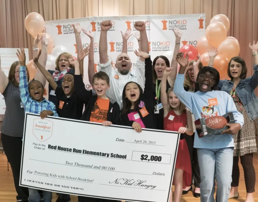 Chef Duff celebrates with the kids and the big check.