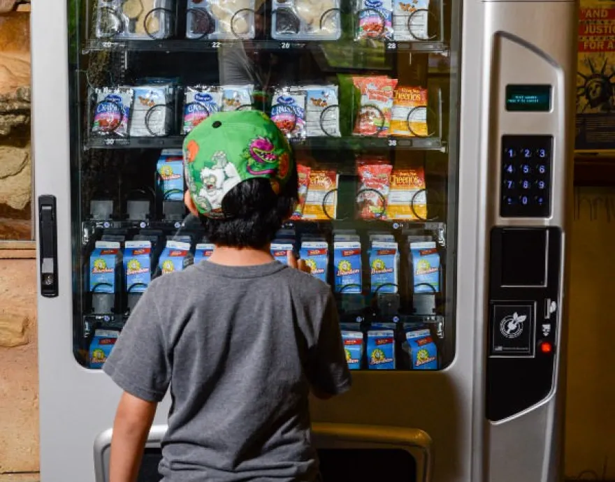 Kid at a vending machine