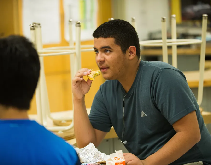 Two students smile in a classroom