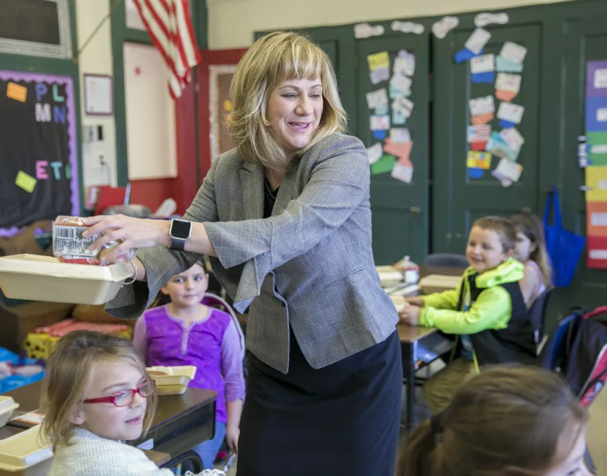 Pam Davis serving breakfast in the classroom