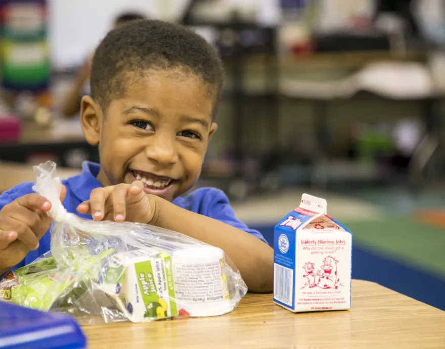 Boy eating breakfast at school