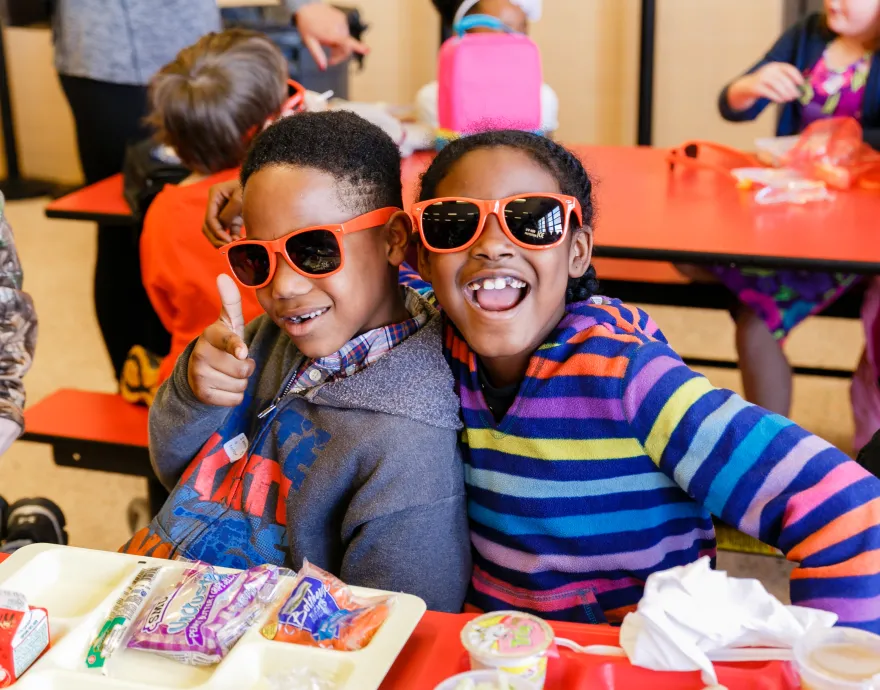 Happy kids wearing No Kid Hungry sunglasses
